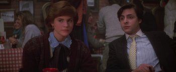 Movie still from “St. Elmo's Fire” (1985), directed by Joel Schumacher – A man and a woman sitting next to each other in a room; Close Up shot, Over the shoulder angle