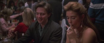 Movie still from “St. Elmo's Fire” (1985), directed by Joel Schumacher – A man and a woman sitting next to each other; Close Up shot, Over the shoulder angle