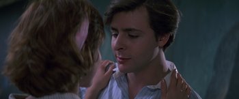 Movie still from “St. Elmo's Fire” (1985), directed by Joel Schumacher – A young girl putting lipstick on a man's face; Close Up shot, Over the shoulder angle