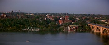 Movie still from “St. Elmo's Fire” (1985), directed by Joel Schumacher – A view of a city from across a body of water; Extreme Wide shot, High angle
