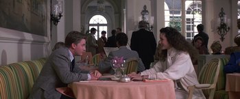Movie still from “St. Elmo's Fire” (1985), directed by Joel Schumacher – A man and a woman sitting at a table in a restaurant; Medium shot, Over the shoulder angle