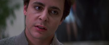 Movie still from “St. Elmo's Fire” (1985), directed by Joel Schumacher – A man's face in a dark room; Close Up shot, Low angle