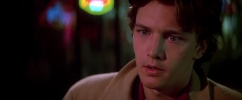 Movie still from “St. Elmo's Fire” (1985), directed by Joel Schumacher – A person wearing a jacket; Close Up shot, Over the shoulder angle