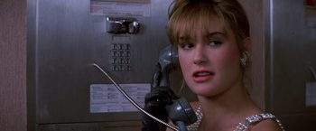 Movie still from “St. Elmo's Fire” (1985), directed by Joel Schumacher – A woman holding a phone up to her ear; Close Up shot, Low angle