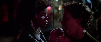 Movie still from “St. Elmo's Fire” (1985), directed by Joel Schumacher – A woman and a man are talking to each other; Close Up shot, Over the shoulder angle