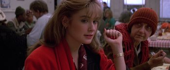 Movie still from “St. Elmo's Fire” (1985), directed by Joel Schumacher – A woman in a red jacket holding her hand up to her face; Close Up shot, Over the shoulder angle