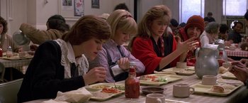 Movie still from “St. Elmo's Fire” (1985), directed by Joel Schumacher – A group of people sitting at a table eating food; Medium shot, High angle