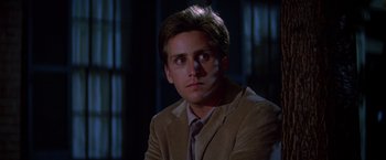 Movie still from “St. Elmo's Fire” (1985), directed by Joel Schumacher – A man in a suit and tie sitting in front of a window; Close Up shot, Over the shoulder angle