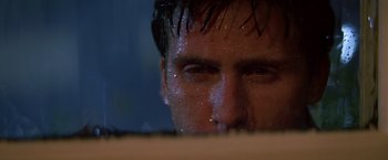 Movie still from “St. Elmo's Fire” (1985), directed by Joel Schumacher – A man's face in the rain; Close Up shot, Low angle