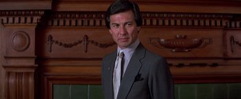 Movie still from “St. Elmo's Fire” (1985), directed by Joel Schumacher – A person wearing a suit and tie; Close Up shot, Low angle