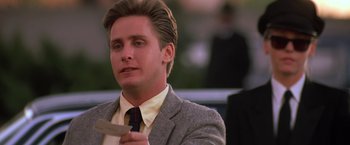 Movie still from “St. Elmo's Fire” (1985), directed by Joel Schumacher – A man in a suit and tie holding a piece of paper; Close Up shot, Low angle