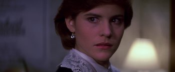 Movie still from “St. Elmo's Fire” (1985), directed by Joel Schumacher – A person wearing a white shirt; Close Up shot, Over the shoulder angle