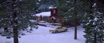 Movie still from “St. Elmo's Fire” (1985), directed by Joel Schumacher – A car parked in front of a house on a snowy day; Extreme Wide shot, High angle