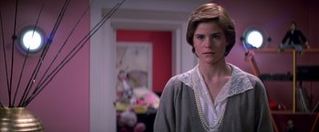 Movie still from “St. Elmo's Fire” (1985), directed by Joel Schumacher – A person wearing pearls and a sweater; Close Up shot, Over the shoulder angle