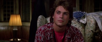 Movie still from “St. Elmo's Fire” (1985), directed by Joel Schumacher – A young man sitting on a chair in front of a mirror; Close Up shot, Over the shoulder angle
