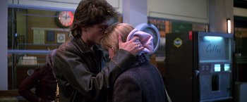 Movie still from “St. Elmo's Fire” (1985), directed by Joel Schumacher – A man and a woman kissing in front of a mirror; Close Up shot, Over the shoulder angle