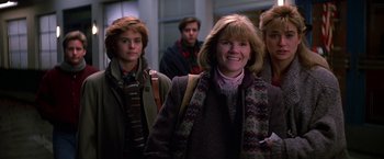 Movie still from “St. Elmo's Fire” (1985), directed by Joel Schumacher – A group of people standing next to each other in a room; Medium shot, Low angle