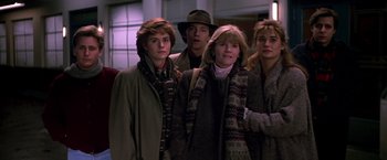 Movie still from “St. Elmo's Fire” (1985), directed by Joel Schumacher – A group of people standing next to each other; Medium shot, Low angle