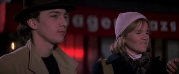 Movie still from “St. Elmo's Fire” (1985), directed by Joel Schumacher – A man and a woman standing next to each other in front of a building; Close Up shot, Over the shoulder angle