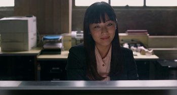 Movie still from “St. Vincent” (2014), directed by Theodore Melfi – A woman sitting at a desk in front of a computer monitor; Close Up shot, Over the shoulder angle