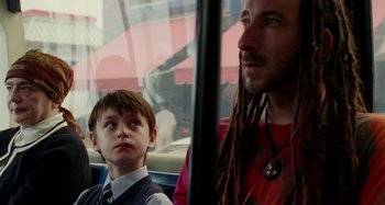 Movie still from “St. Vincent” (2014), directed by Theodore Melfi – A man with dreads sitting next to a young boy; Close Up shot, Over the shoulder angle