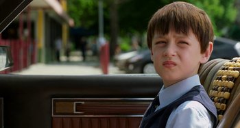 Movie still from “St. Vincent” (2014), directed by Theodore Melfi – A young boy sitting in the back seat of a car; Close Up shot, Low angle