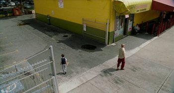Movie still from “St. Vincent” (2014), directed by Theodore Melfi – A man and a boy walking down the sidewalk; Extreme Wide shot, High angle