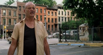 Movie still from “St. Vincent” (2014), directed by Theodore Melfi – An older man standing on the side of the street; Medium shot, Low angle
