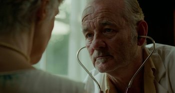 Movie still from “St. Vincent” (2014), directed by Theodore Melfi – An older man with a stethoscope around his neck; Close Up shot, Over the shoulder angle