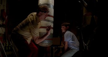Movie still from “St. Vincent” (2014), directed by Theodore Melfi – A man and a boy are playing a game; Medium shot, Low angle