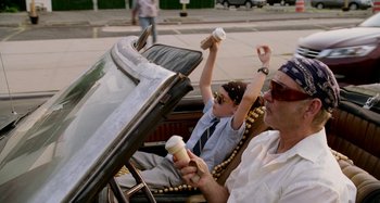 Movie still from “St. Vincent” (2014), directed by Theodore Melfi – A man and a woman are riding in a car; Medium shot, Low angle