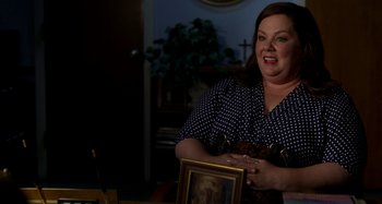 Movie still from “St. Vincent” (2014), directed by Theodore Melfi – A woman standing in front of a painting; Medium shot, High angle