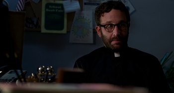 Movie still from “St. Vincent” (2014), directed by Theodore Melfi – A man wearing glasses sitting in front of a desk; Close Up shot, Over the shoulder angle