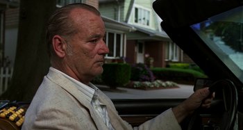 Movie still from “St. Vincent” (2014), directed by Theodore Melfi – An older man sitting in the back of a car; Close Up shot, Over the shoulder angle