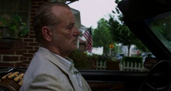 Movie still from “St. Vincent” (2014), directed by Theodore Melfi – An older man sitting in the back seat of a car; Close Up shot, Low angle