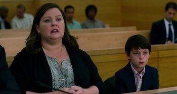 Movie still from “St. Vincent” (2014), directed by Theodore Melfi – A woman and a boy are in a courtroom; Medium shot, Over the shoulder angle