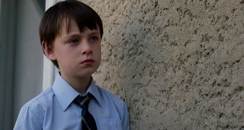 Movie still from “St. Vincent” (2014), directed by Theodore Melfi – A young boy in a dress shirt and a tie; Close Up shot, Low angle