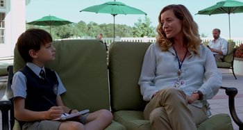 Movie still from “St. Vincent” (2014), directed by Theodore Melfi – A woman sitting on a couch next to a boy; Medium shot, Over the shoulder angle