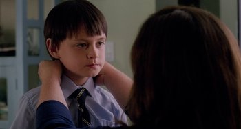 Movie still from “St. Vincent” (2014), directed by Theodore Melfi – A young boy wearing a neck tie looking at a woman; Close Up shot, Over the shoulder angle