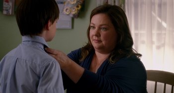 Movie still from “St. Vincent” (2014), directed by Theodore Melfi – A woman is helping a boy with a tie; Close Up shot, Over the shoulder angle