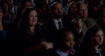 Movie still from “St. Vincent” (2014), directed by Theodore Melfi – A group of people sitting in a room; Medium shot, High angle