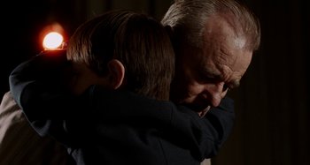 Movie still from “St. Vincent” (2014), directed by Theodore Melfi – An older man and a young boy are hugging; Close Up shot, Over the shoulder angle