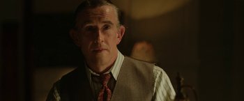 Movie still from “Stan & Ollie” (2018), directed by Jon S. Baird – A person wearing a suit and a tie; Close Up shot, Over the shoulder angle