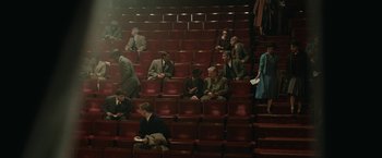 Movie still from “Stan & Ollie” (2018), directed by Jon S. Baird – A group of people sitting in rows of red seats; Extreme Wide shot, High angle