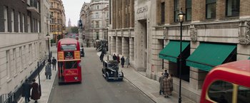 Movie still from “Stan & Ollie” (2018), directed by Jon S. Baird – People walking on the sidewalk of a city street; Extreme Wide shot, High angle