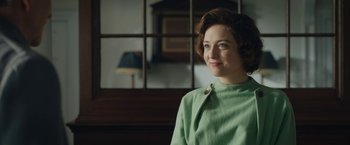 Movie still from “Stan & Ollie” (2018), directed by Jon S. Baird – A woman in a green dress sitting in front of a window; Close Up shot, Over the shoulder angle