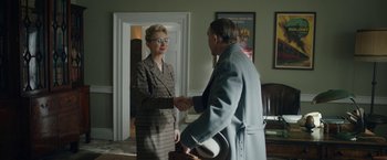 Movie still from “Stan & Ollie” (2018), directed by Jon S. Baird – A man and a woman shaking hands in a living room; Medium shot, Over the shoulder angle