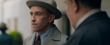 Movie still from “Stan & Ollie” (2018), directed by Jon S. Baird – A man wearing a suit and a hat looking at another man; Close Up shot, Over the shoulder angle