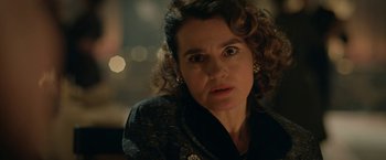 Movie still from “Stan & Ollie” (2018), directed by Jon S. Baird – A person with curly hair wearing a suit; Close Up shot, Over the shoulder angle