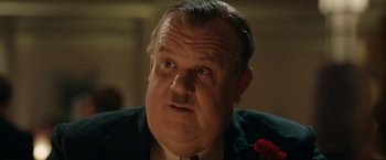 Movie still from “Stan & Ollie” (2018), directed by Jon S. Baird – An older man with a mustache and a beard wearing a suit and tie; Close Up shot, Low angle